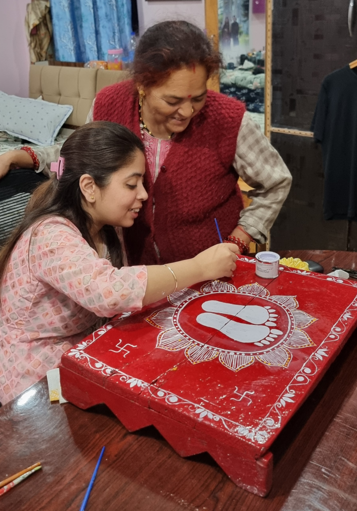 Aipan art - mother teaching her daughter